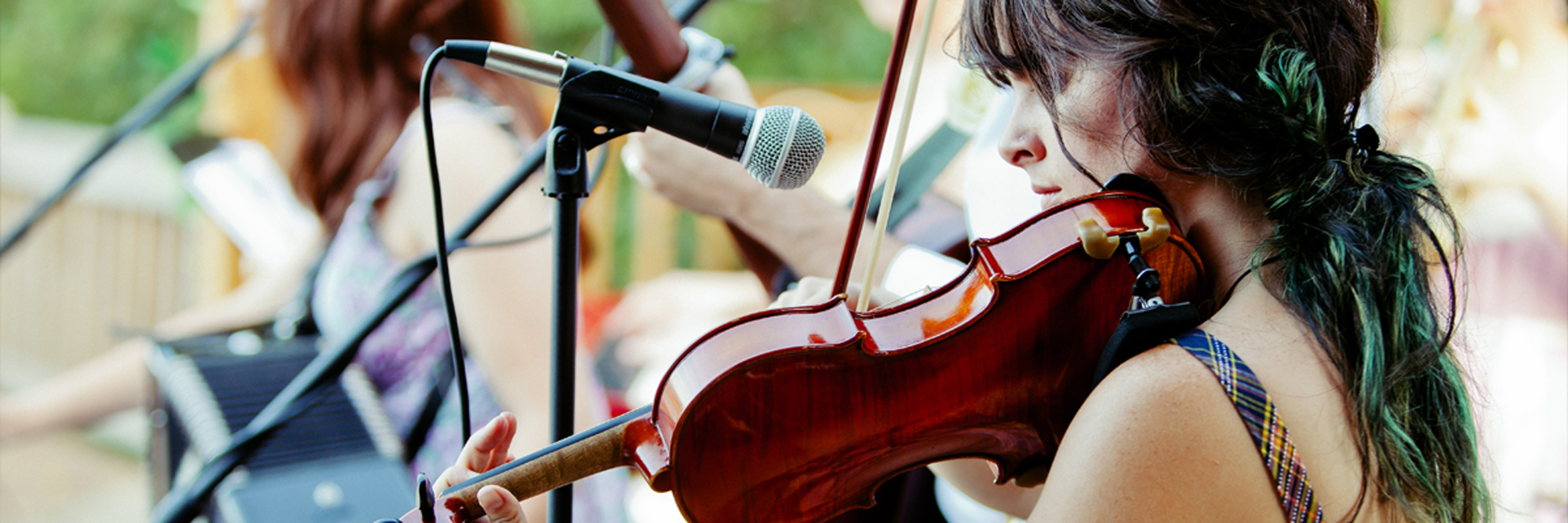 Woman practicing violin on stage