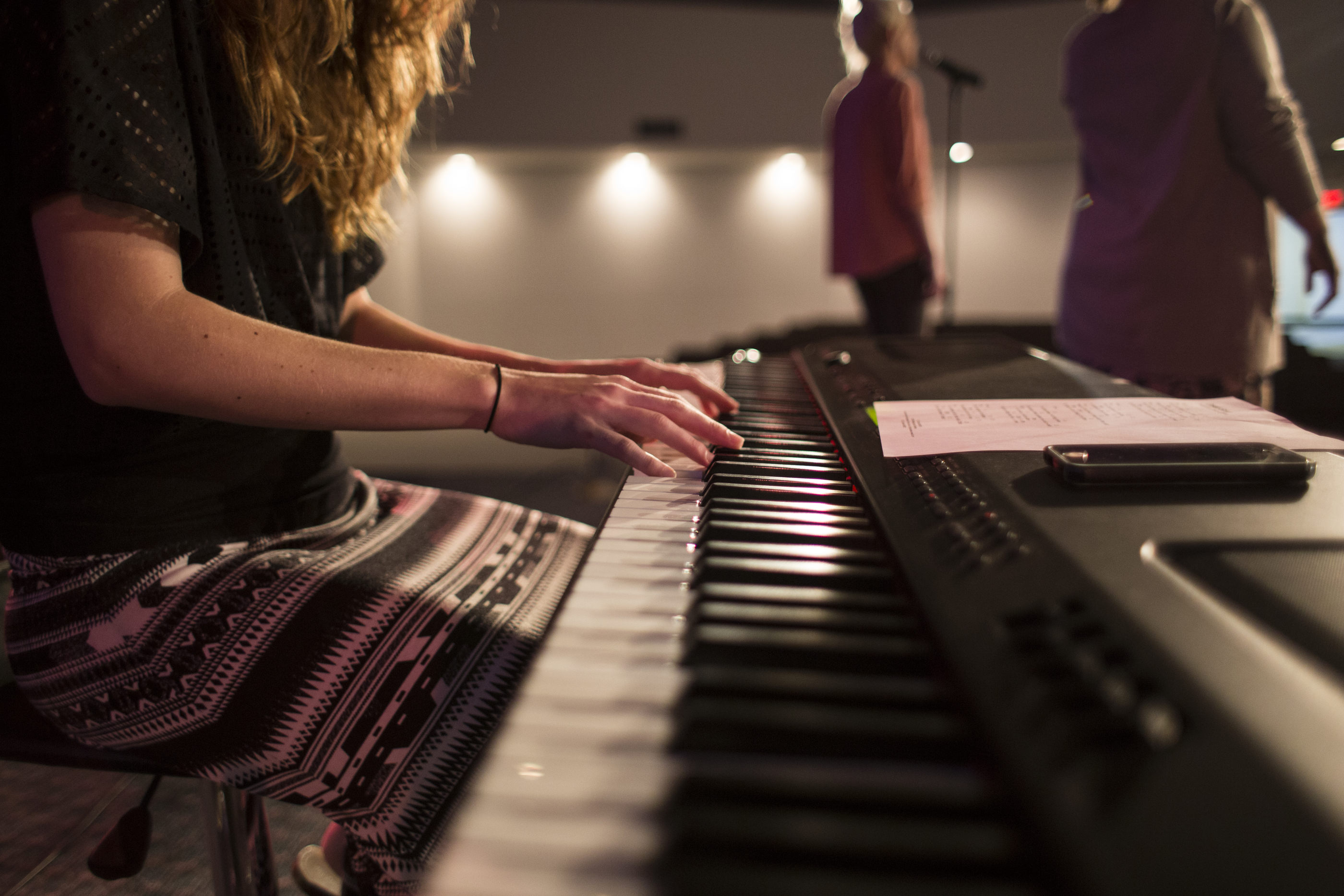 Woman on stage playing keyboard